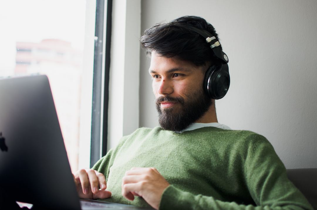 Image- A guy with headphones and laptop
