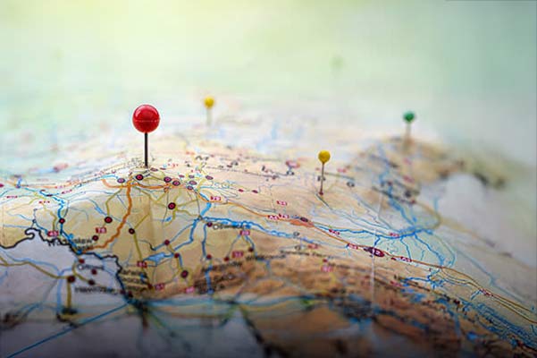 Image of a map of the globe with a pin in it