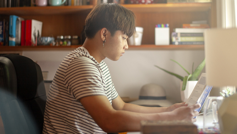 Image - Asian man reading a book 800px
